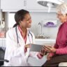 Health care attorney and medical professional discussing legal documents in an office