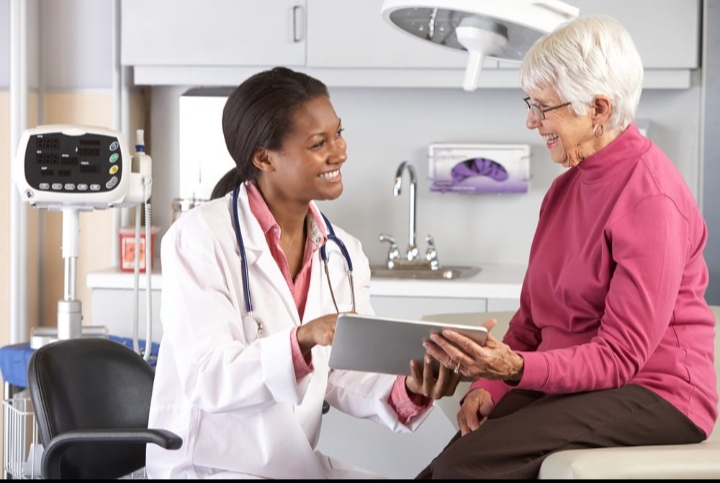 Health care attorney and medical professional discussing legal documents in an office